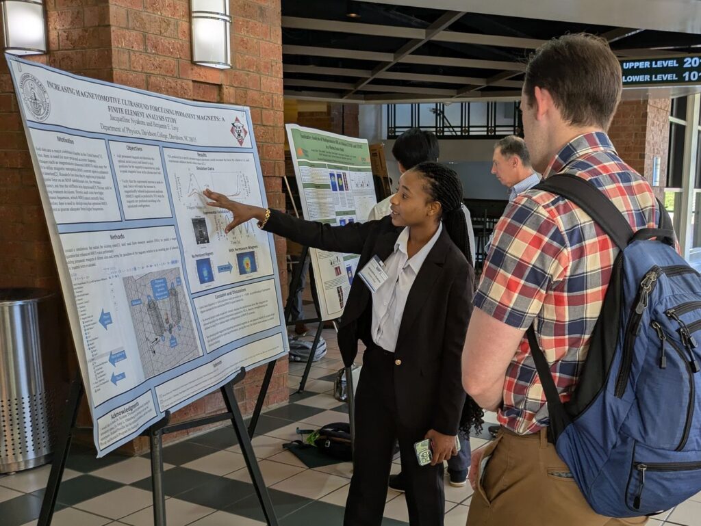 Jae presents her her research to a physicist at SESAPS